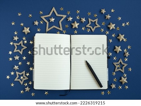 Open diary for plans for the new year with pen decorated with stars n blue background. Concept of planning new year. Foto stock © 