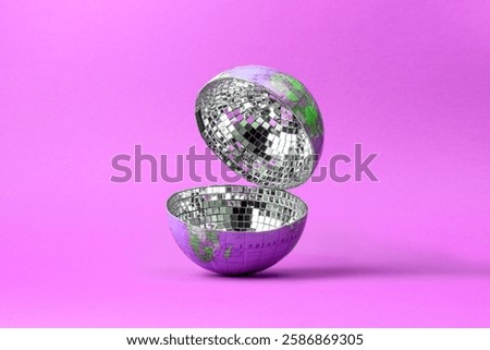 An open disco ball in the shape of a globe with a mirrored mosaic inside on a pink background. A conceptual composition symbolizing global culture.