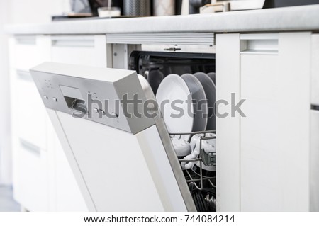 Open dishwasher with clean dishes after washing