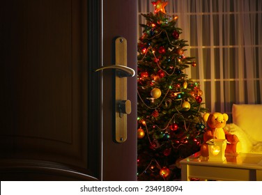 Open Door With Decorated Christmas Tree In Room