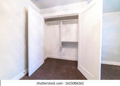 Open Door Of An Empty Clothes Closet