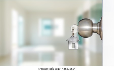 Open door with keys, key in keyhole
