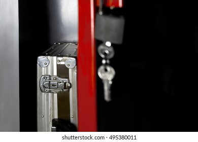 Open Door Of A Metal Safe With A Briefcase Inside, Cropped Studio Shot, Concept Of Safety Or Negligence. Focus In The Foreground