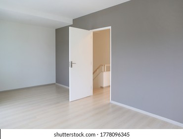 Open door in the white room of new house