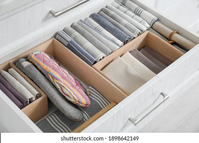 Open drawer with different textiles in kitchen, above view