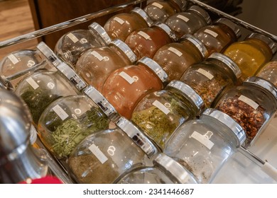 open drawer with rows of spices in small glass jar labeled aligned - Powered by Shutterstock