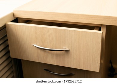 Open drawer of a wooden table lose up