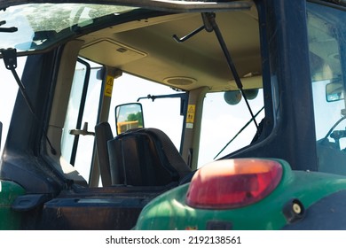 Open Drivers Cabin On A Combine Harvester. Harvesting Oilseed Rape On A Field. High Quality Photo