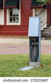 An Open Electrical Box In Green Grass