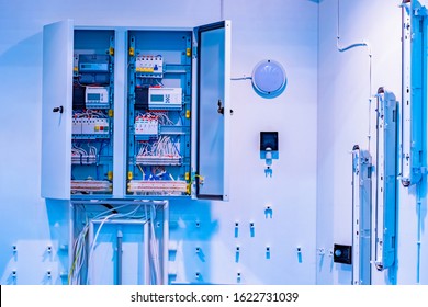 Open Electrical Cabinet At The Enterprise. Utility Room. Cabinet With Electric Wires And Counters. Cabinet With Electrical Control Devices In A Factory. Room With Electrical Sensors. 