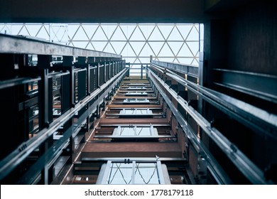 Open elevator lift shaft. Modern architecture with transparent ceiling. Shopping mall or business center. Maintenance repair and service