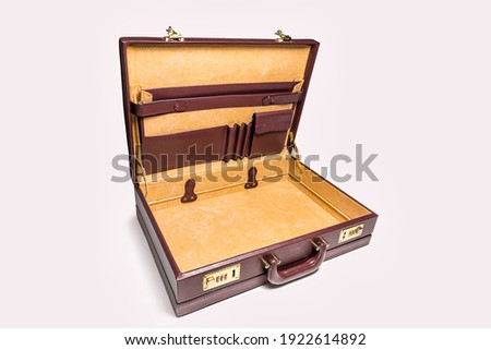 Open and empty 24 hour briefcase on white background