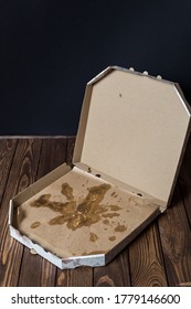 Open Empty Cardboard Pizza Box. After Meal. Dirty Dishes.