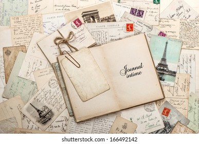 open empty diary book, old letters, french postcards. nostalgic vintage scrapbook background with sample text Journal intime (Diary) in french - Powered by Shutterstock