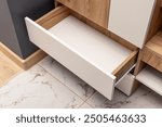 An open empty drawer in wooden cabinet. Wooden furniture