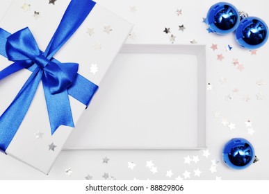 Open Empty Gift Box With Blue Ribbon, Confetti And Balls