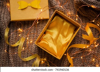 open empty gift box on white table. Colorful Gift box with ribbon bow present on holiday
Yellow Gift box with yellow and golden ribbon bow present to New Year or Christmas - Powered by Shutterstock