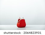 Open Empty Red Coin Purse on blue background with copy space, minimalistic style. Charge purse. Open empty coin wallet
