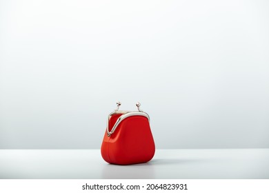 Open Empty Red Coin Purse on blue background with copy space, minimalistic style. Charge purse. Open empty coin wallet