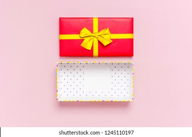 Open Empty Red Gift Box With Gold Ribbon On Light Pink Background Top View Flat Lay. Holiday Concept, Birthday Gift, Surprise, New Year Or Christmas Gift Box. Congratulations Background Copy Space.