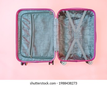 Open Empty Suitcase On Pink Background.