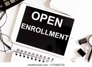 OPEN ENROLLMENT/ Business Concept On White Background With Office Tools