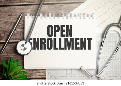 Open Enrollment Sign On Notebook With Stethoscope And Cardio Charts