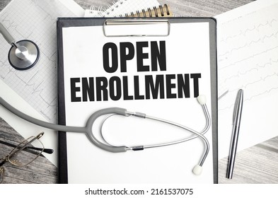 Open Enrollment Sign On Notebook With Stethoscope And Cardio Charts