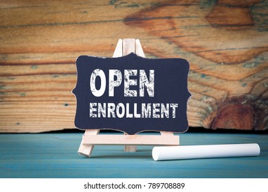 Open Enrollment. small wooden board with chalk on the table