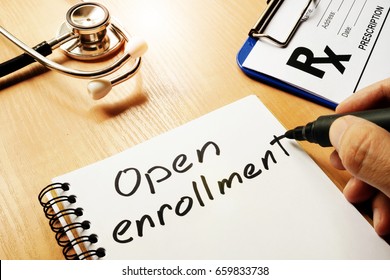 Open enrollment written on a note and medical stethoscope. - Shutterstock ID 659833738
