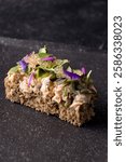 Open faced sandwich (smorrebrod) with salmon salad, finger lime and microgreens