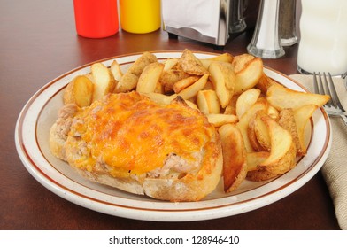 An Open Faced Tuna Melt With Potato Wedges And A Glass Of Milk