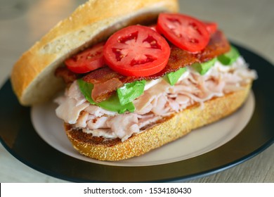 Open Faced Turkey Club Sandwich On Fresh Sourdough With Avocado And Bacon. 