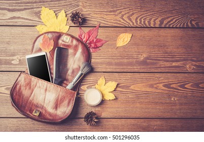 Open Fashionable Women's Handbag On Wooden Background