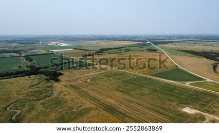 Open fields and trees with a highway across Kansas