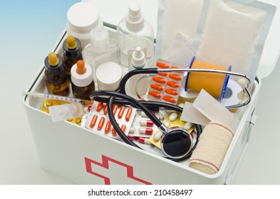 Open First Aid Box Filled With Medical Supplies In Blue Background