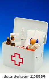 Open First Aid Box Filled With Medical Supplies In Blue Background