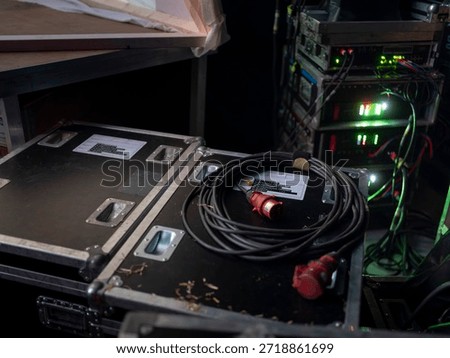 Open flight case with electrical distribution box and power cables for stage setup