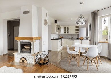 Open floor flat with fireplace, dining area and light open kitchen - Powered by Shutterstock