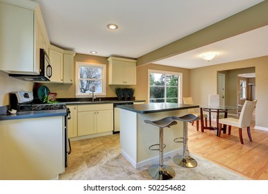 Open Floor Plan White Kitchen Room Interior With Island And Dining Area. Northwest, USA