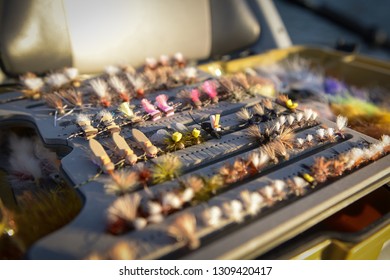 An Open Fly Box Sits On A Raft During A Summer Fishing Trip Into The Backcountry Of Montana.