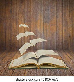 Open Flying Old Books In Wood Room