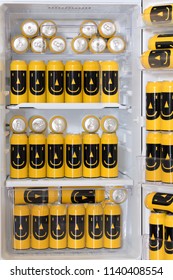 The Open Fridge Is Full Of Colored Cans With A Drink. Stock Of Beer In The Refrigerator At Home. A Fridge Filled With Cans Of Beer With A Funny Image.