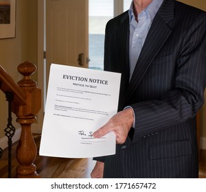 Open Front Door With Man In Suit Handing An Eviction Notice To A Defaulting Renter In Modern Home Due To Missed Rent