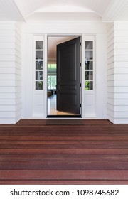 Open Front Door With Wood Decking.