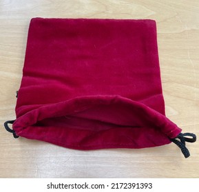 An Open Fronted Red Velvet Fabric Draw String Bag