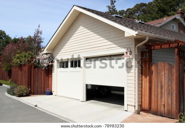 Open garage door in\
suburban house
