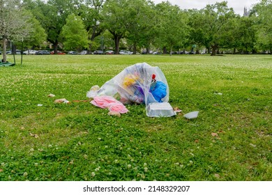 Open Garbage Bag With Trash Spilling Out Left After Easter Sunday Picnic In Audubon Park In New Orleans, LA, USA