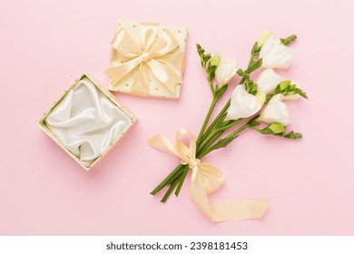 Open gift box, with fresia flower color background, top view - Powered by Shutterstock