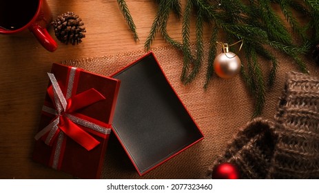 Open Gift Box On Wooden Background With Christmas Decorations. Celebrations And Holiday Concept. Top View, Flat Lay